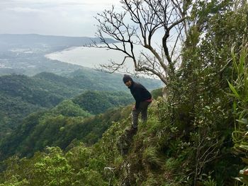 Full length of man on tree against mountain