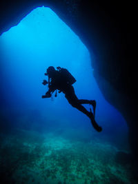 Scuba diver swimming in sea