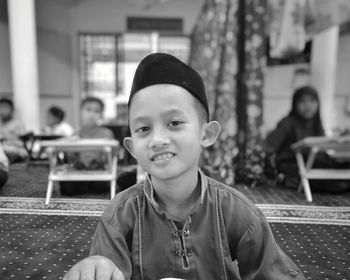 Portrait of smiling boy in traditional clothing at home