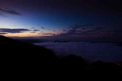 Scenic view of silhouette mountains against sky during sunset