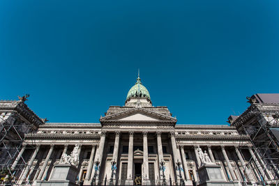 Low angle view of historical building against blue sky