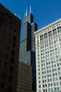 Low angle view of tall buildings against clear sky
