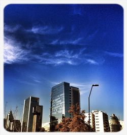 Low angle view of buildings against cloudy sky