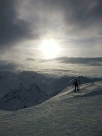 Silhouette of mountain against cloudy sky