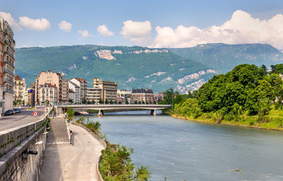 Panoramic view of buildings and mountains against sky