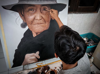 High angle portrait of man with arms raised
