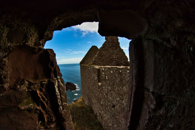 Rock formations by sea against sky