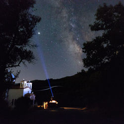 Scenic view of illuminated building against sky at night