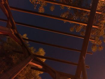 Low angle view of metal structure against sky at night