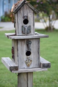Close-up of birdhouse on wooden post