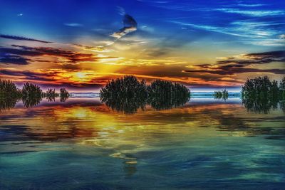 Scenic view of lake against sky during sunset