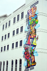 Low angle view of multi colored building against sky