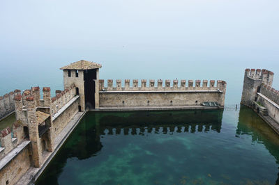 Bridge over water against clear sky