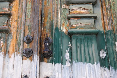 Detail of picturesque traditional portuguese door in a very bad condition