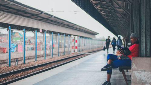 People waiting at railroad station platform