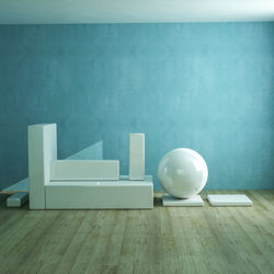 White table and chairs on hardwood floor against wall at home