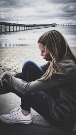 Girl sitting on pier