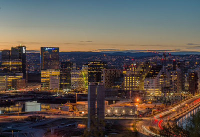 High angle view of city lit up at night