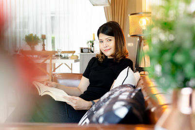 Portrait of woman sitting at home