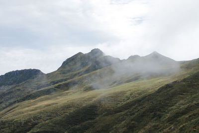 Scenic view of mountains against a foggy sky in auvergne. 