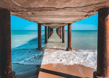 Scenic view of sea against sky seen through pier