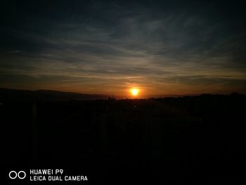 Silhouette of moon at sunset