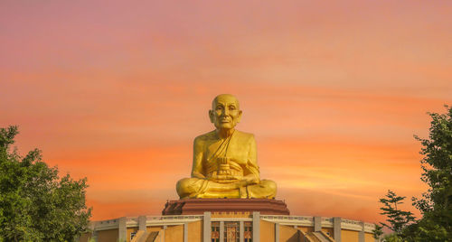 Low angle view of statue against sky during sunset