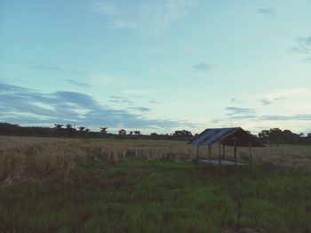 Scenic view of farm against sky