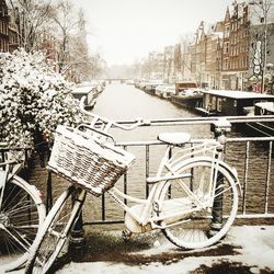 Bicycle parked against sky in city