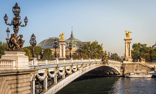 The magnificent alexandre iii bridge over the seine river with the grand palais in paris