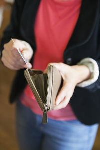 Woman holding wallet and credit card