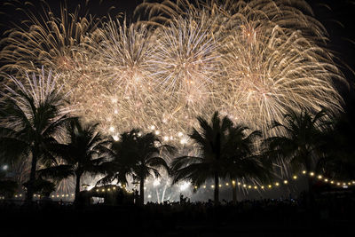 Low angle view of firework display at night