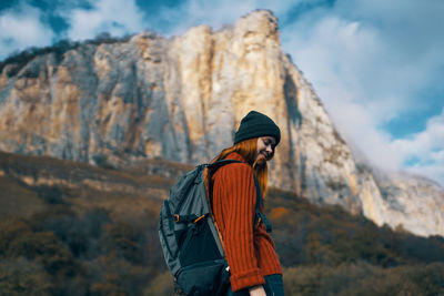 Man standing on rock against mountains