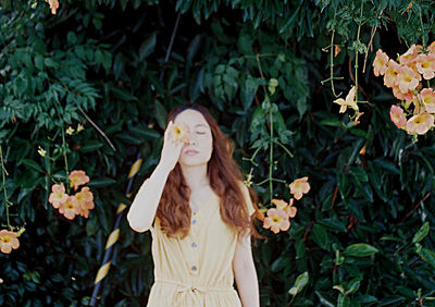 Woman standing by plants