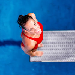 High angle portrait of mid adult woman standing on diving platform