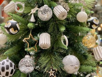 Close-up of christmas decorations hanging on tree