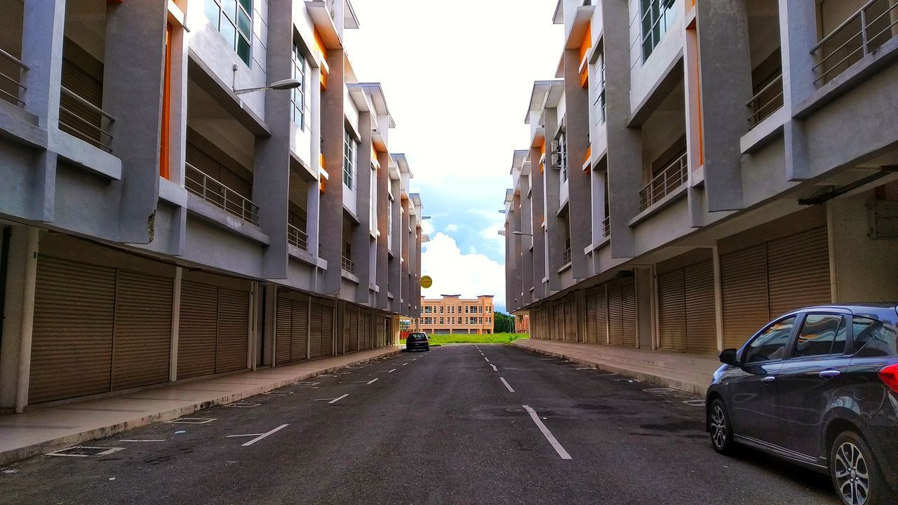 ROAD AMIDST BUILDINGS IN CITY