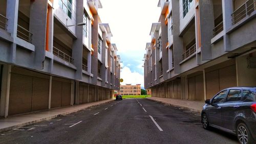 Cars on road amidst buildings in city