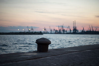 Pier by sea against sky during sunset