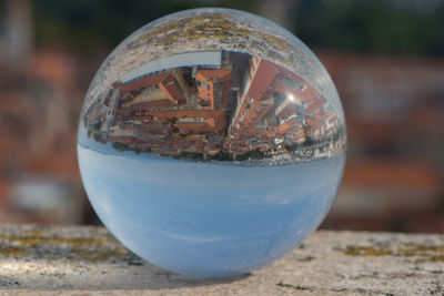 Close-up of metallic ball on glass