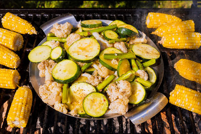 High angle view of fruits and vegetables on barbecue