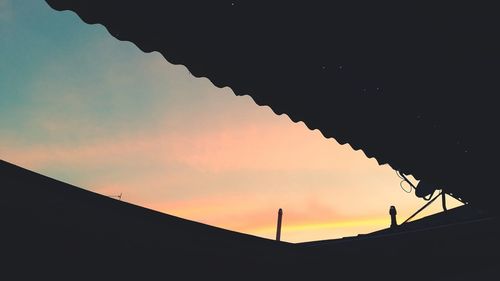 Low angle view of silhouette building against sky during sunset