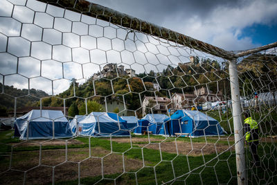 View of soccer field seen through chainlink fence