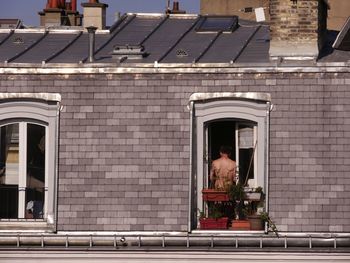 Rear view of people walking on building