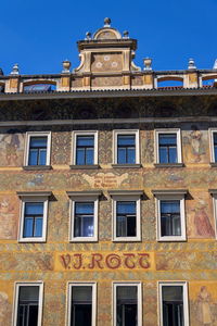 Low angle view of old building against blue sky