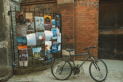 Bicycles on wall against building in city