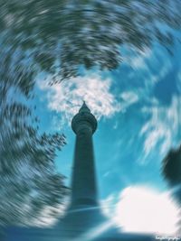 Low angle view of tower against cloudy sky