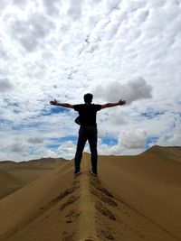 Rear view of man standing on desert