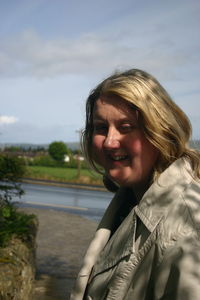 Portrait of smiling woman against sky