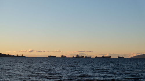 Scenic view of sea against clear sky during sunset